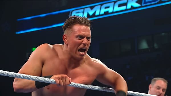 The Miz leans over the WWE SmackDown ropes, shouting angrily with a fierce expression. The SmackDown logo glows in the background.
