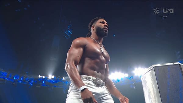 Trick Williams stands in the wrestling ring under bright arena lights, with the WWE and USA Network logos visible. The moment suggests a WWE storyline involving Sami Zayn and the