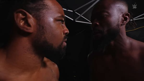 Xavier Woods and Kofi Kingston of The New Day face off closely in a tense backstage WWE Raw moment. The WWE logo appears in the corner.
