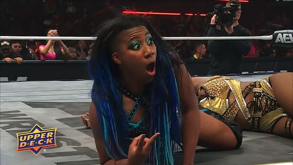 Athena looks shocked on the AEW Collision mat after failing to pin Maya World, with the crowd and ringside camera visible behind her.