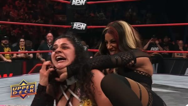 Mercedes Moné traps Persephone in a chokehold during an AEW Collision match, with both wrestlers straining in the ring.