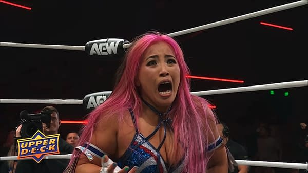 Mina Shirakawa, with bright pink hair, shouts inside the AEW wrestling ring during AEW Collision. She appears to be reacting intensely in the middle of a match.