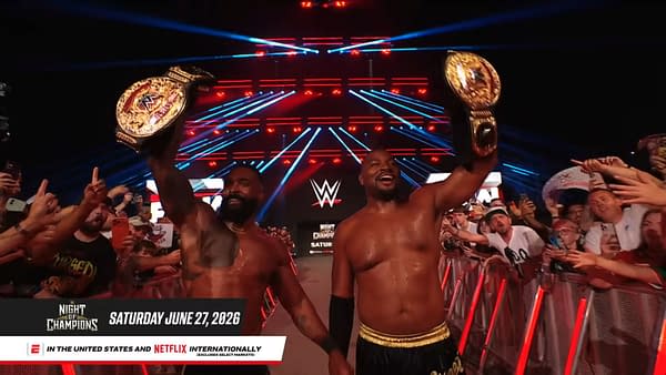 The Street Profits walk the WWE Raw entrance ramp in London, raising gold championship belts above a cheering crowd. Red and blue stage lights glow behind them.