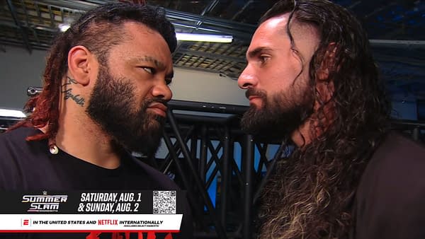 Jacob Fatu and Seth Rollins stare each other down backstage on WWE Raw, locked in a tense face-to-face confrontation.