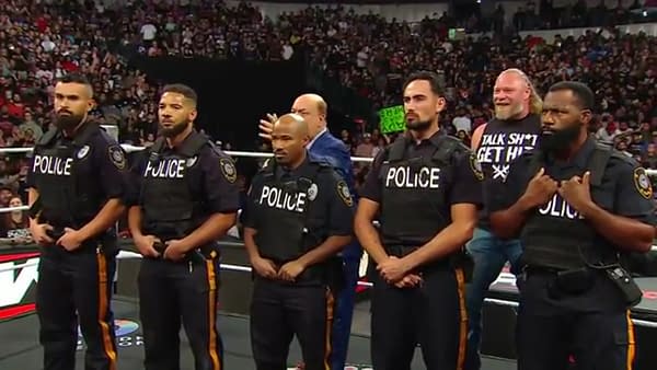 A wall of police protect Brock Lesnar from Oba Femi on WWE Raw