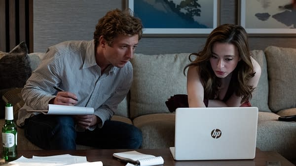 A man taking notes and a woman using an HP laptop lean over a coffee table in a tense social media or business strategy meeting.