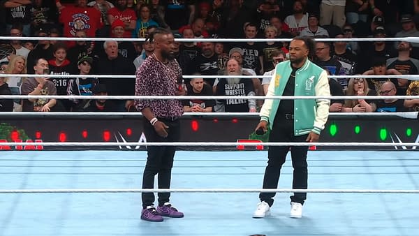 Kofi Kingston and Xavier Woods of The New Day stand in a WWE ring, facing each other during a tense in-ring segment as the crowd watches. Both look serious, suggesting a possible betrayal storyline.
