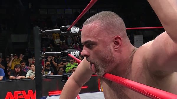 On AEW Collision, wrestler Eddie Kingston hangs one arm over the middle rope, the other grasping the top, as he recovers from a grueling match with Jake Doyle from which he emerged victorious.