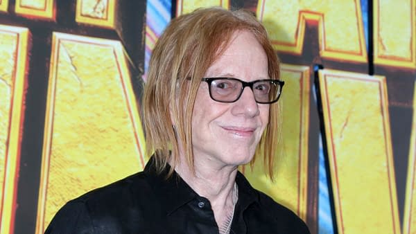 Danny Elfman poses on the red carpet at the Stuart Fails To Save The Universe series premiere in Los Angeles, wearing glasses and a black shirt.