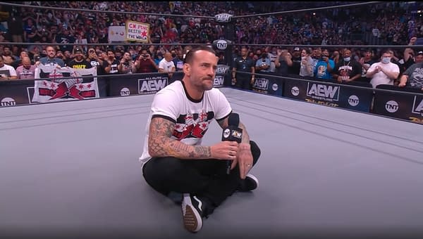 CM Punk sits in the middle of an AEW ring on his return to wrestling on AEW Rampage: The First Dance