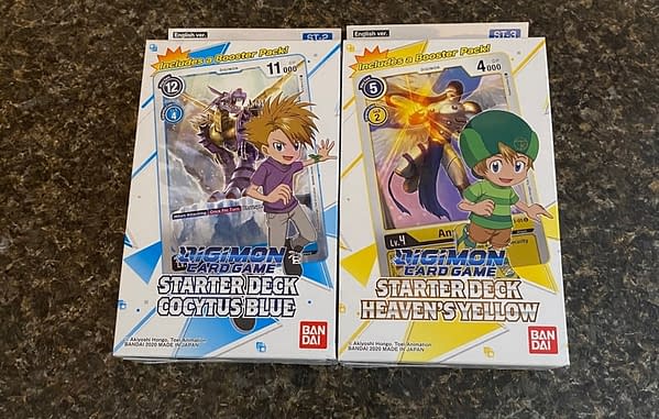 The Cocytus Blue and Heaven's Yellow starter decks from the Digimon Card Game by Bandai. Not pictured: Gaia Red.