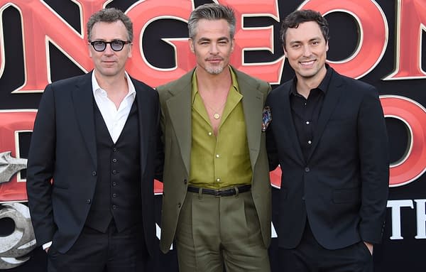 Jonathan Goldstein, Hugh Grant, and a third man pose together on the red carpet at the Dungeons & Dragons: Honor Among Thieves premiere.