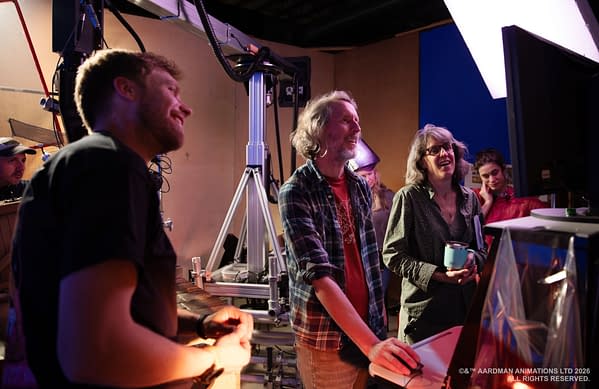 A behind-the-scenes photo shows the Shaun the Sheep: The Beast of Mossy Bottom animation team gathered around a monitor in a studio, smiling and reviewing a scene.