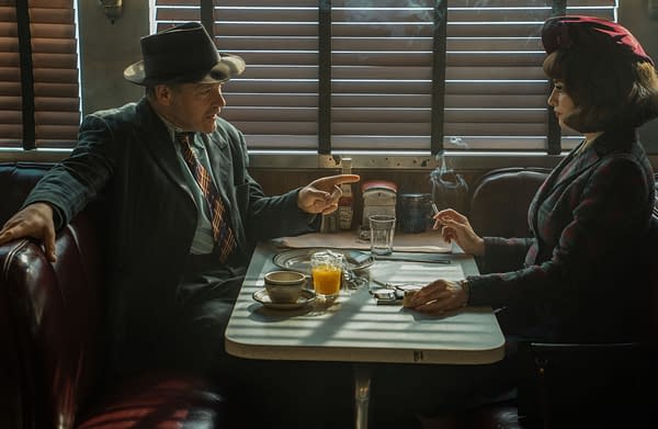 A vintage diner scene featuring a man in a hat gesturing animatedly at a woman sitting across the table, who is smoking and holding a small box. Light streams through wooden blinds, casting shadows on the table, which is set with breakfast items and drinks.