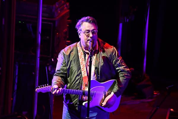 They Might Be Giants' vocalist and guitarist John Flansburgh, somehow wearing a warm-looking jacket while performing two sets under heavy stage lighting. Photo credit: Britt Bender