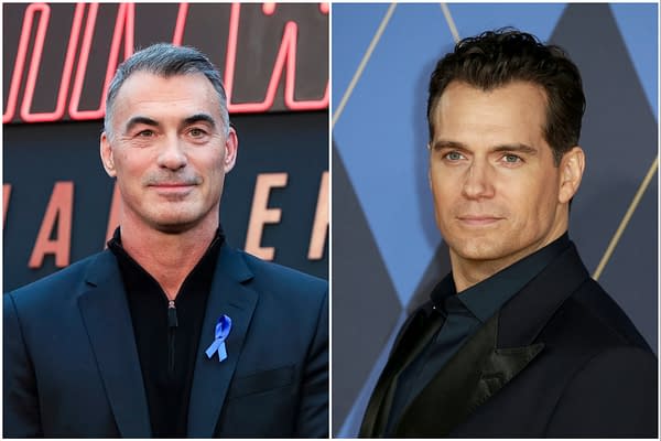 Two well-dressed men are featured side by side, one wearing a black zip-up jacket with a blue ribbon on the left lapel, and the other in a dark suit with a buttoned shirt. The background includes the word 'Highlander' in bold letters, suggesting a connection to the Highlander franchise.