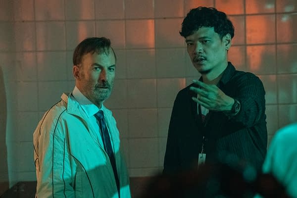 Behind-the-scenes photo from 'Nobody 2' featuring Bob Odenkirk and director Timo Tjahjanto, engaged in conversation on set.