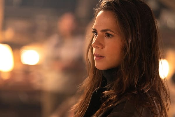 Hayley Atwell as Grace in a scene from 'Mission: Impossible - The Final Reckoning', featuring her with long hair and an intense expression, set against a softly lit background.