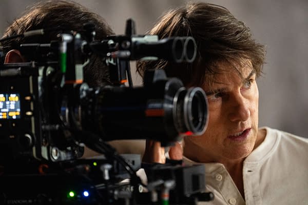 Tom Cruise is seen on the set of 'Mission: Impossible - The Final Reckoning,' focusing intently in front of a film camera.