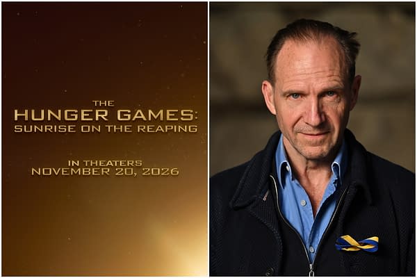 A promotional image from 'The Hunger Games: Sunrise on the Reaping,' featuring actor Ralph Fiennes with a serious expression, wearing a blue shirt and a black coat, and a ribbon pinned to his lapel. The background is softly blurred, focusing on Fiennes as the text for the movie is displayed prominently in gold.