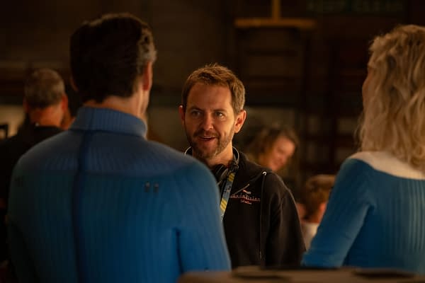 Director Matt Shakman talks with actors on the set of 'The Fantastic Four: First Steps,' set in a studio environment, featuring crew members in the background.