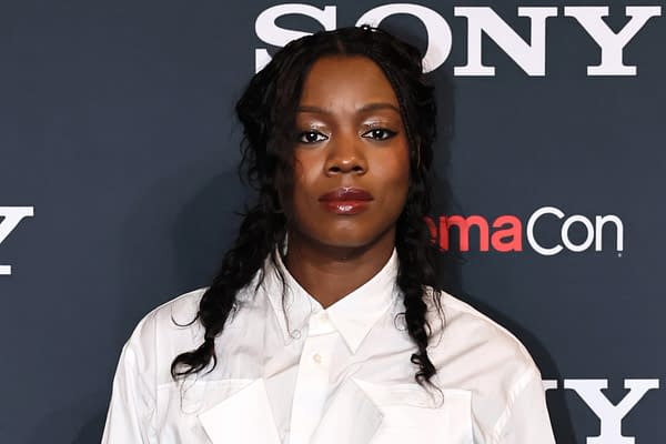 A young woman with braided hair wears a white button-up shirt and poses in front of a dark background featuring the 'Sony' logo and 'CinemaCon' text.