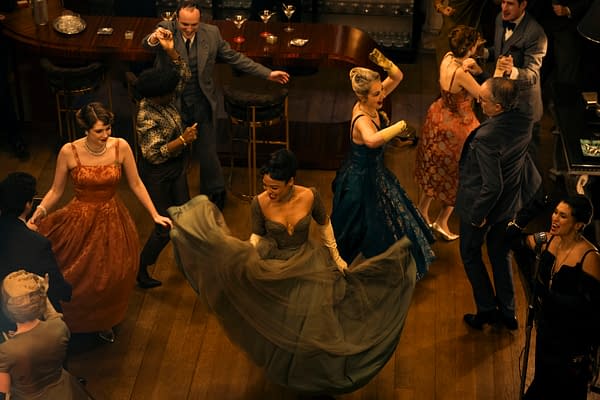 A vibrant scene from a dance party showcasing elegantly dressed individuals in various colorful gowns and suits, with a focus on a woman wearing a flowing dress and gloves, capturing the lively atmosphere of the event.