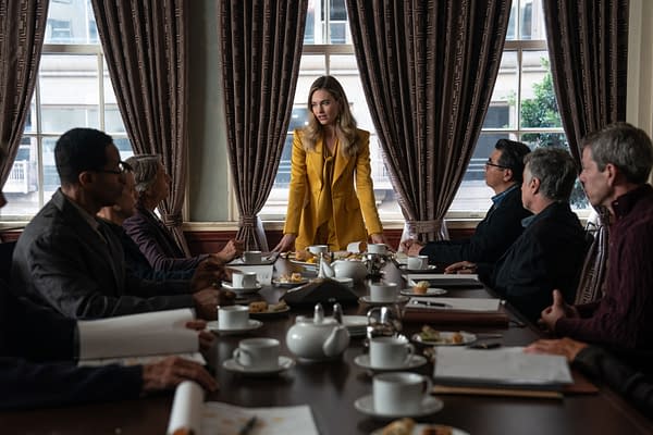 A scene from the film 'Swiped' featuring Lily James as Whitney Wolfe Herd, standing confidently at a conference table surrounded by a group of men, all engaged in discussion. The room has elegant curtains and a view of the city outside.
