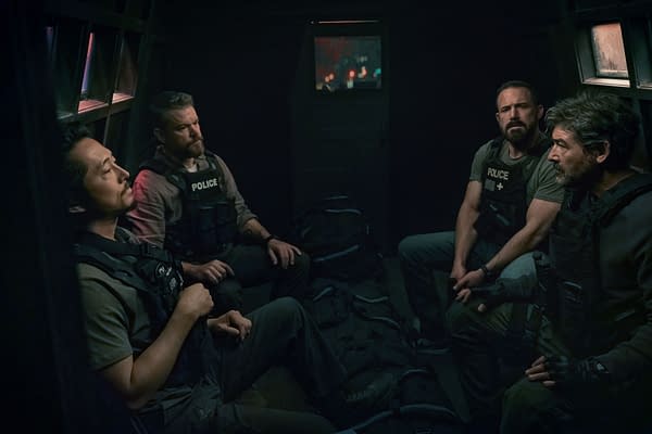 A dramatic scene from 'The Rip' featuring four law enforcement officers seated inside a dimly lit vehicle, showcasing a tense atmosphere as they prepare for action.