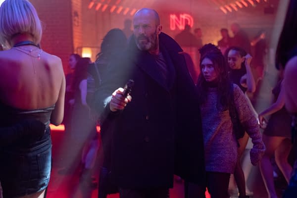 A dramatic scene in a nightclub featuring a man in a dark coat holding a gun, looking tense, accompanied by a startled woman in a sweater. The background is filled with people dancing under moody lighting, with a neon sign partially visible.