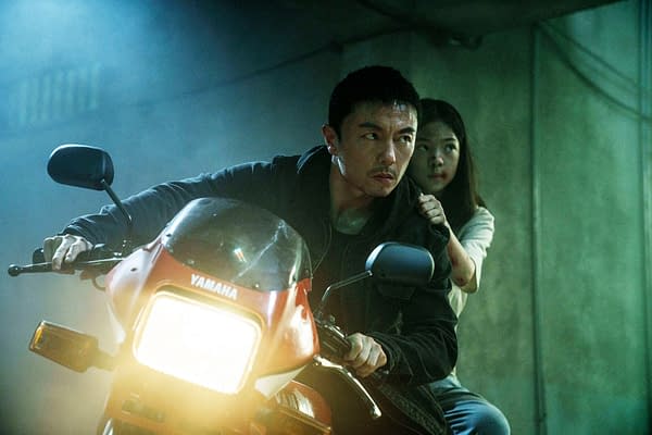 A scene from 'The Furious' featuring a man riding a Yamaha motorcycle in a dimly lit environment, with a young woman gripping his shoulder from behind, suggesting a tense situation.