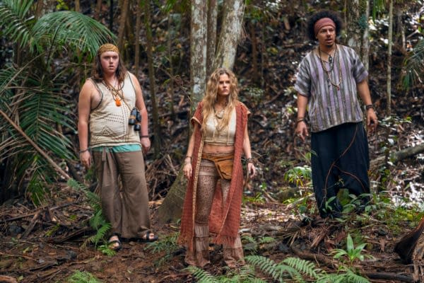 Three characters from 'Balls Up' stand in a lush forest environment, dressed in eco-themed attire. They embrace an adventurous spirit, showcasing elements related to nature and sustainability.