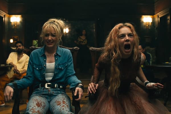 A scene from 'Ready Or Not 2: Here I Come' featuring two characters, one in a blue denim outfit with a distressed appearance and the other in a bloodied dress, both showing intense emotions in a tense setting. The background contains dim lighting and shadows, enhancing a suspenseful atmosphere.