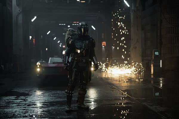 The Mandalorian stands in a dimly lit urban environment, with Grogu perched on his back, while sparks fly nearby, showcasing a tense but dynamic scene from the series.