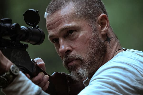 Brad Pitt, as James Belmont in Heart of the Beast, aims a scoped rifle with a tense, focused expression.
