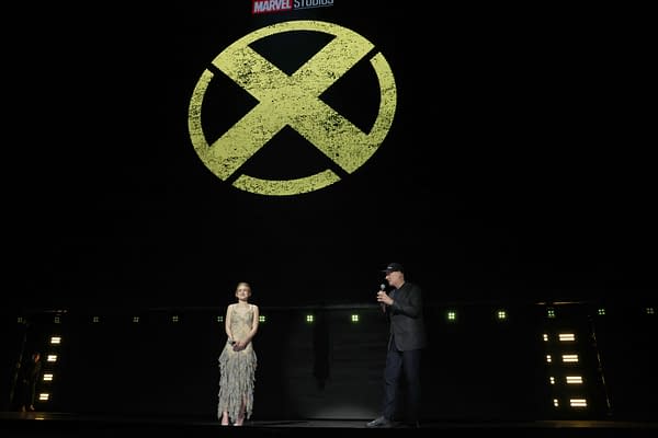 Sadie Sink and Kevin Feige speak onstage at Disney Entertainment Showcase beneath a large X-Men logo at D23 2026.