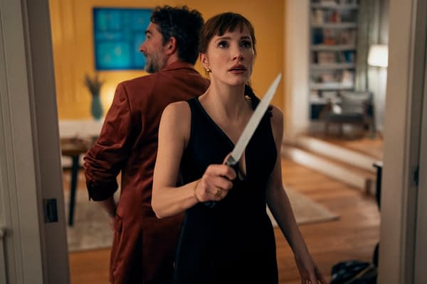 Jessica Chastain, as Mommy in Other Mommy, holds a knife while standing back-to-back with Jay Duplass in a tense living room scene.