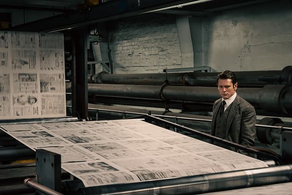 Jack O'Connell as Lamb stands beside a printing press as newspapers roll through an industrial press room in Ink.