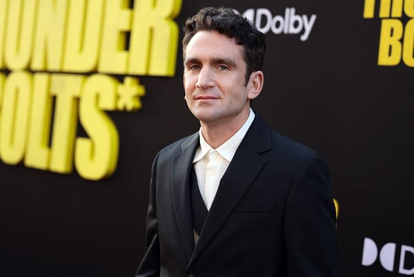 Jake Schreier at the world premiere of Marvel Studios' "Thunderbolts*" in Hollywood, wearing a black suit and white shirt, against a background featuring the event title in bold yellow letters.