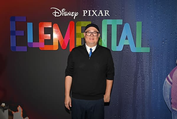 Director Peter Sohn stands in front of a colorful backdrop featuring the title "Elemental" at the UK Gala Screening in London, promoting Disney and Pixar's film.