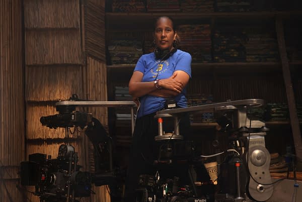 Director Gina Prince-Bythewood stands on the set of Children of Blood and Bone beside camera equipment, arms crossed.