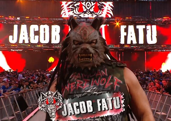 Jacob Fatu makes his entrance for a cage match at WWE SummerSlam, wearing a wolf mask and themed attire, surrounded by an excited crowd and a vibrant stage backdrop.