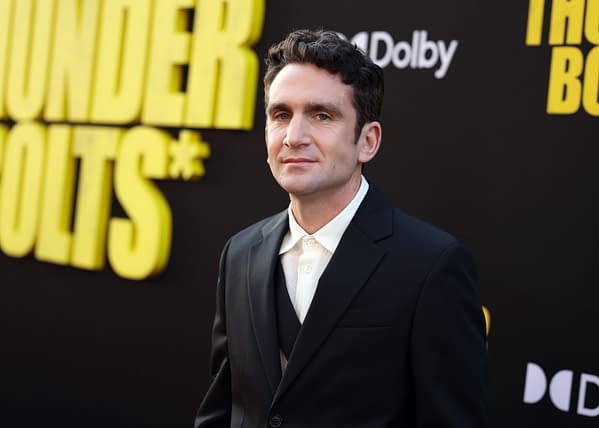 Jake Schreier at the world premiere of Marvel Studios' "Thunderbolts*" in Hollywood, wearing a black suit and white shirt, against a background featuring the event title in bold yellow letters.