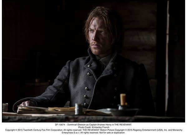 Domhnall Gleeson as Captain Andrew Henry in a dark, moody setting from THE REVENANT, wearing a military-style coat, appearing contemplative.