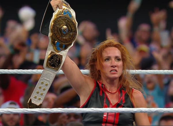 A wrestler with long red hair, Becky Lynch, holds up a championship belt triumphantly in the wrestling ring, surrounded by cheering fans at WWE SummerSlam.