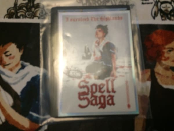 An add-on of promotional cards and a sticker for Spell Saga. Apologies for the blur. (Photo credit: Josh Nelson)