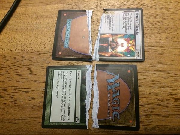 Two ripped-up Magic: The Gathering cards - one real and the other fake. We hate to have had to do this but it proves another good point.