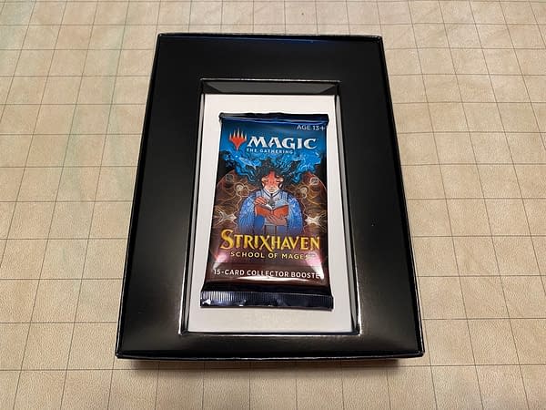 The inside of the Strixhaven: School of Mages collector booster box for Magic: The Gathering. Inside is only one pack and a bit of cardboard to contain it.