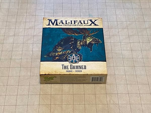 The front of the box for The Damned, a miniature for the objective-based skirmish game known as Malifaux Third Edition, by Wyrd Miniatures.