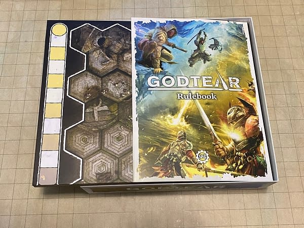 The core rulebook for Steamforged Games' tabletop board game Godtear, as well as the game board for this game.